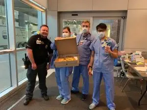 doctors at cox south ER holding boxes of pizza delivered by Vito's Kitchen